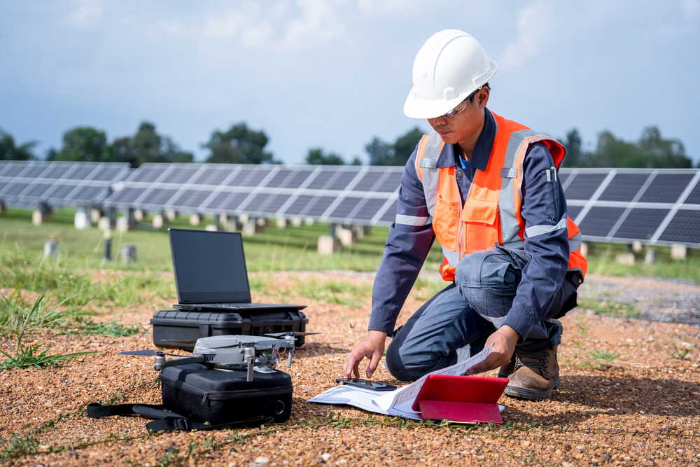 Surveyor reviewing drone capture data on laptop in the field